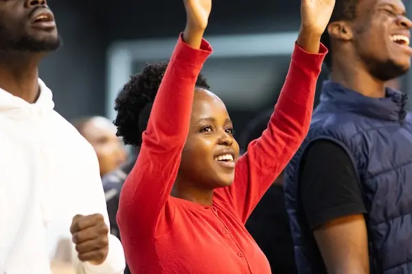 smiling with lifted hands