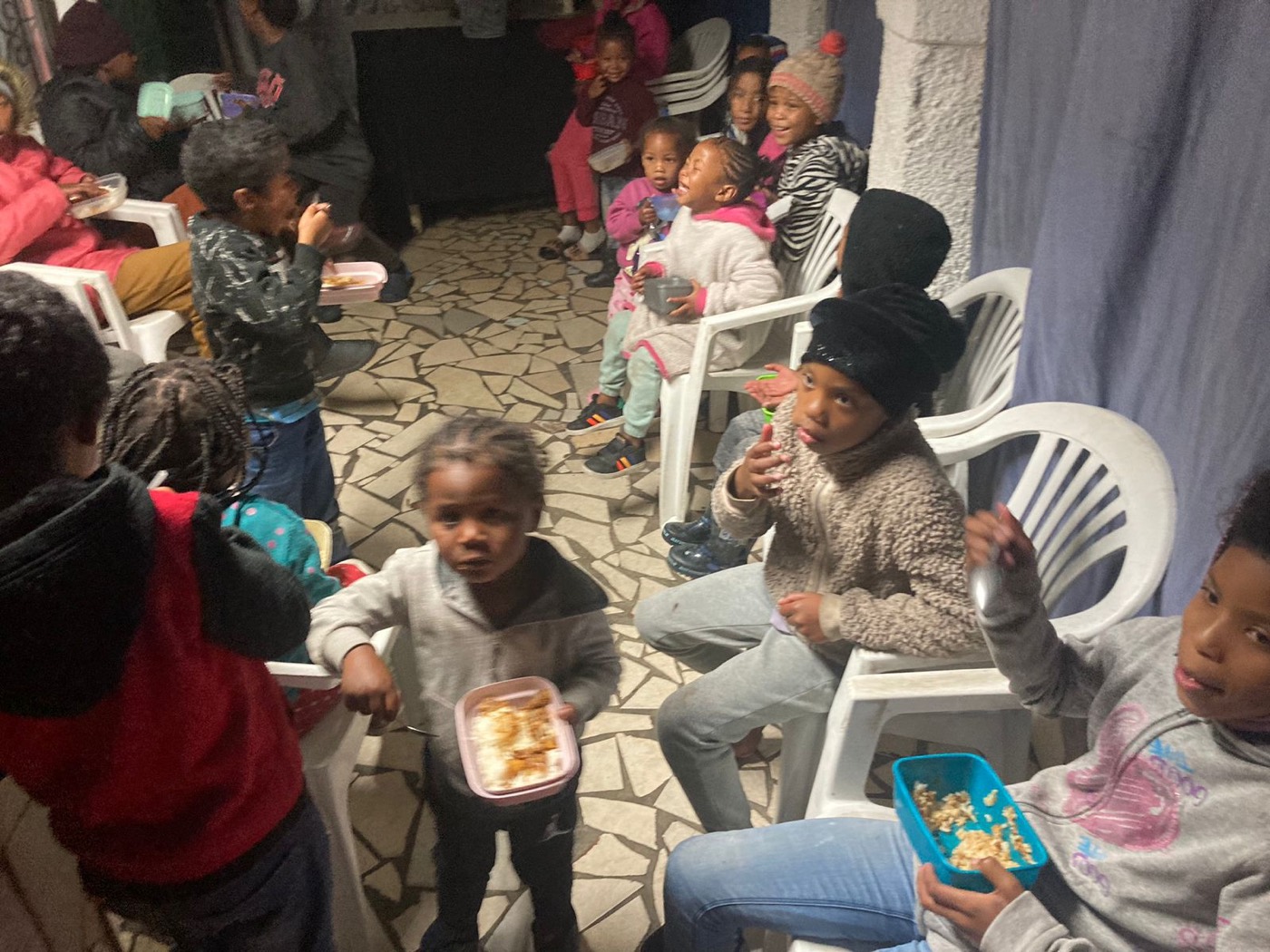 An evening outreach where children are served a warm meal